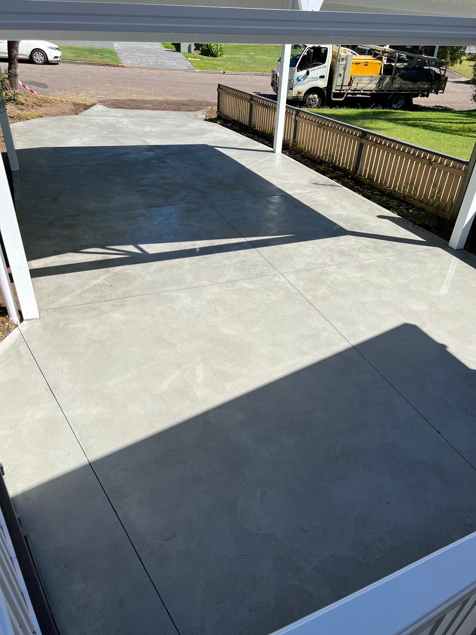 A Concrete Driveway With a Truck Parked in the Background — Coastal Kerb and Concrete In Buff Point, NSW