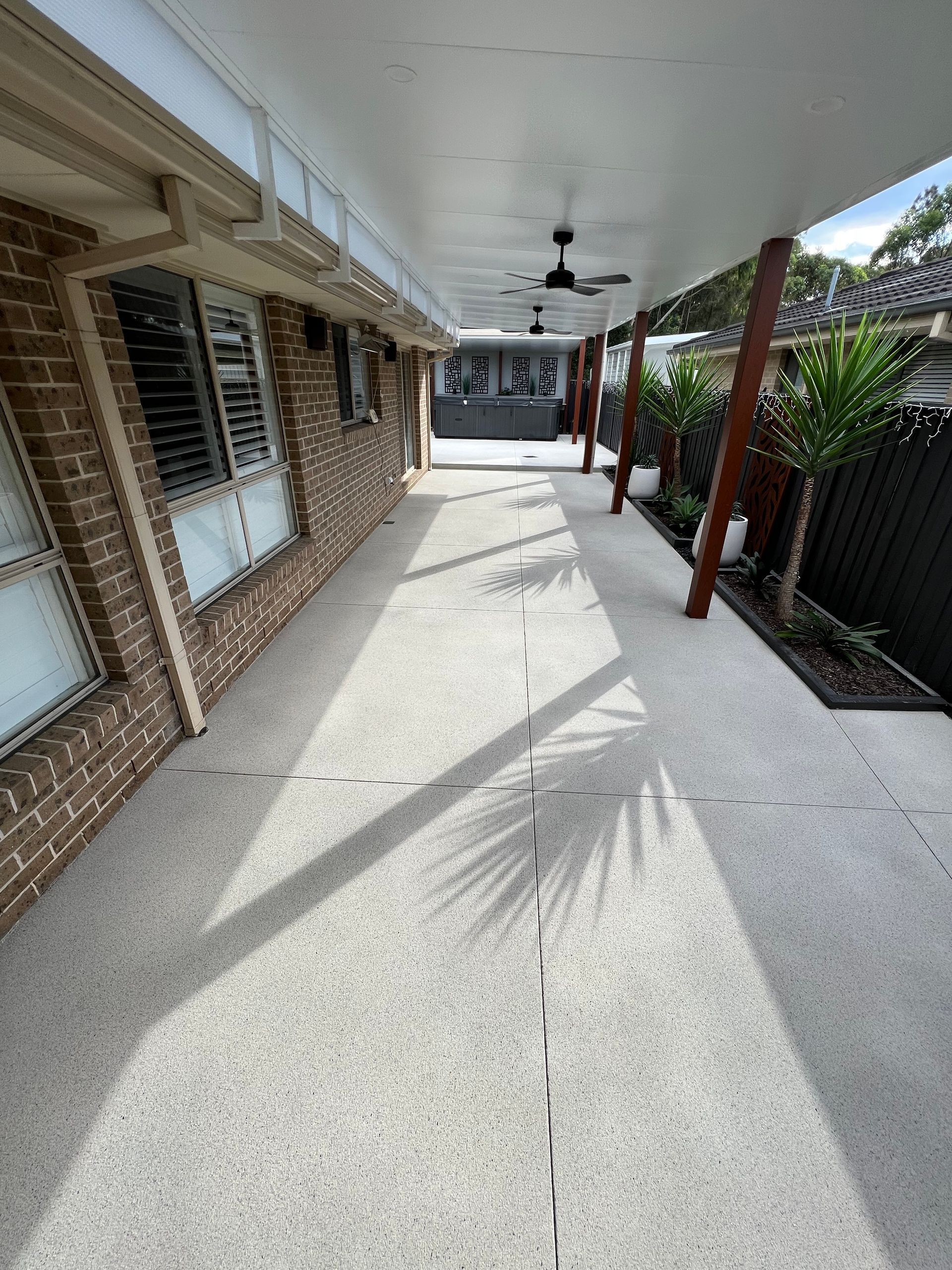 A Long Walkway Leading to a House With a Ceiling Fan — Coastal Kerb and Concrete In Buff Point, NSW