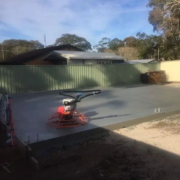 A Machine is Sitting on Top of a Concrete Surface — Coastal Kerb and Concrete In Buff Point, NSW
