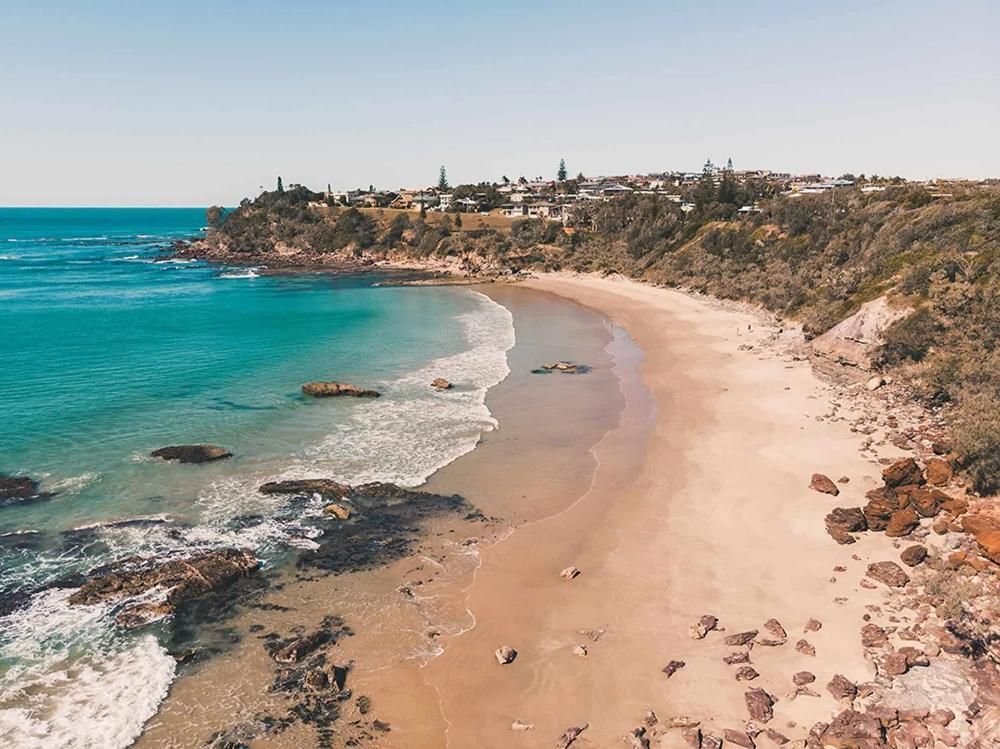 An Aerial View of a Beach With a City in the Background — Coastal Kerb and Concrete In Lake Macquarie, NSW