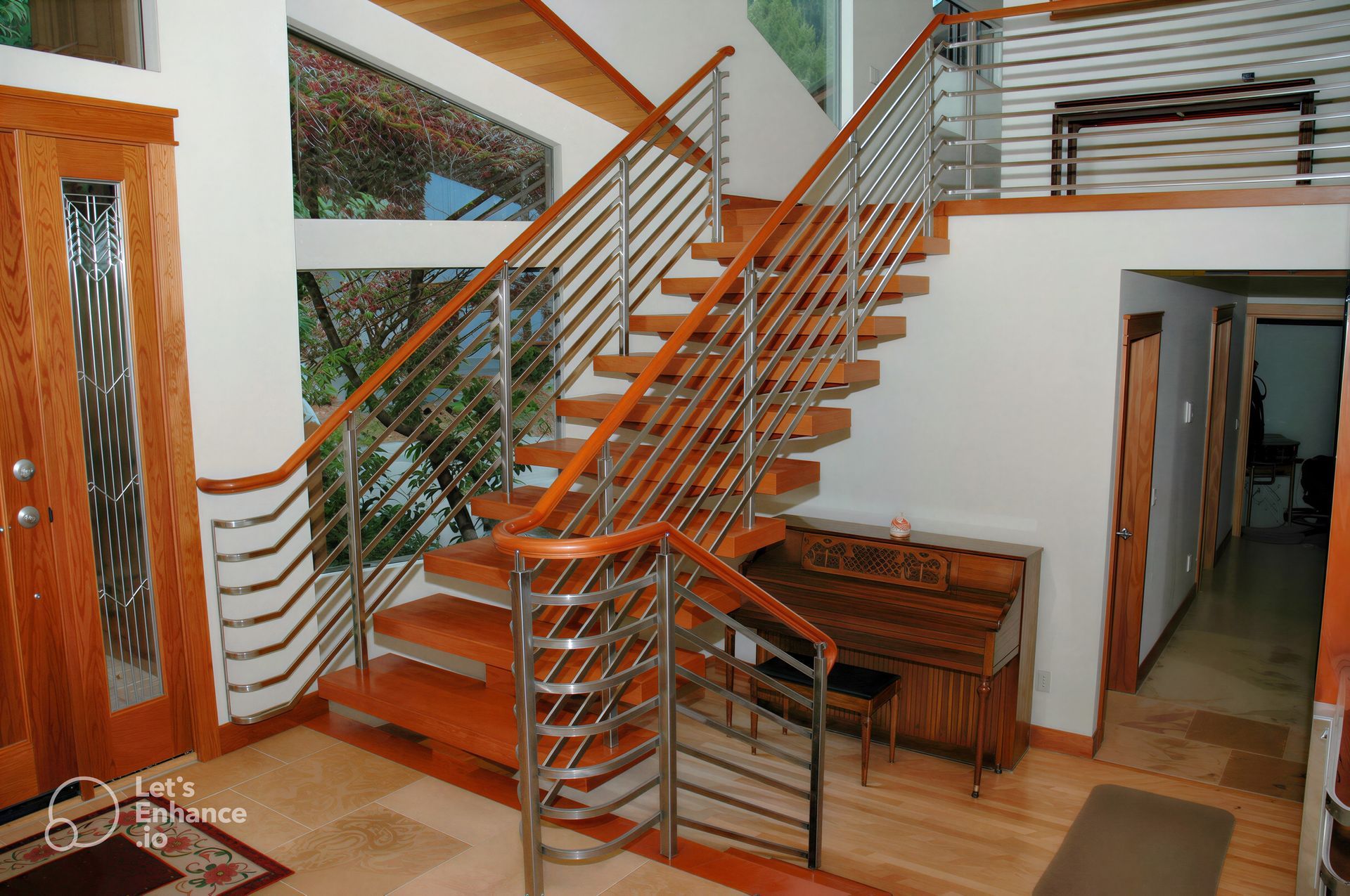 Modern staircase with wooden steps and metal railing in a bright home interior