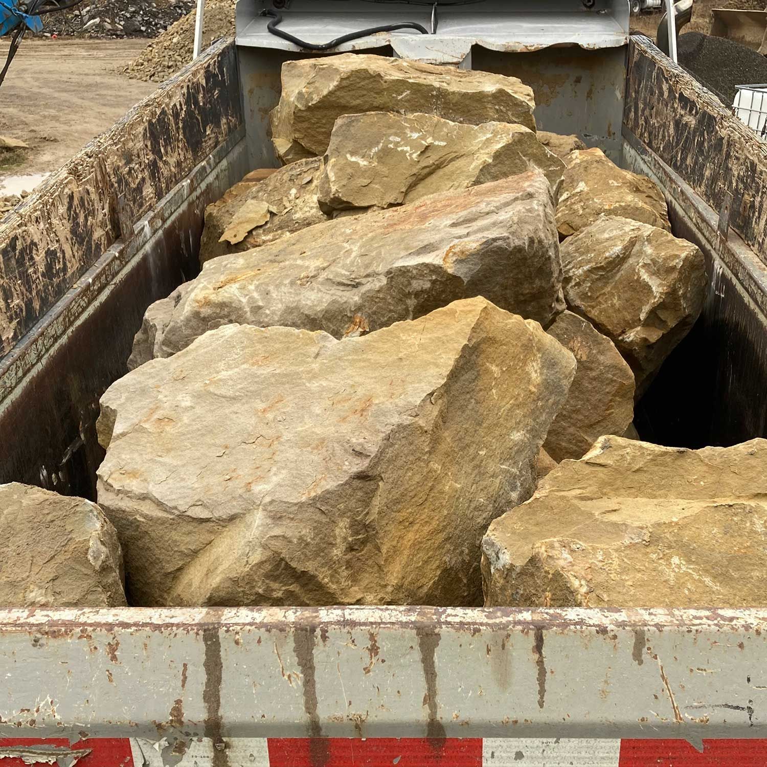 Natural stone steps and retaining walls are features in a luxury garden