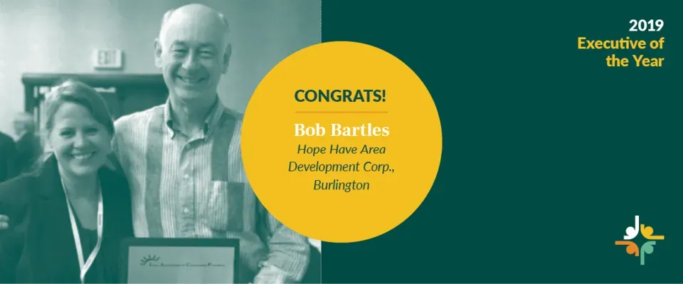 2019 Executive of the Year banner with a smiling honoree holding an award and a yellow congratulatory circle