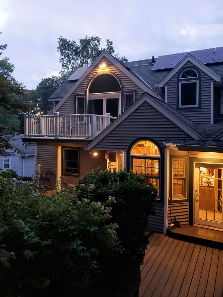 A homeowners insurance form with a pen and a wooden house on a table.
