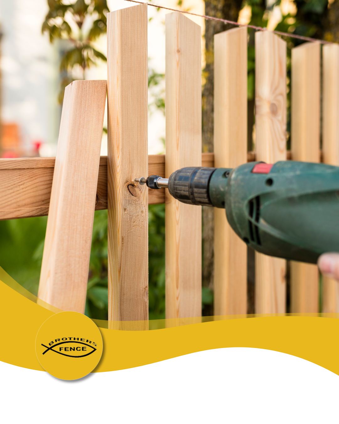 Person using a drill to attach a wooden fence picket; outdoor setting with greenery.