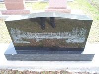 Black granite headstone with etched landscape scene.