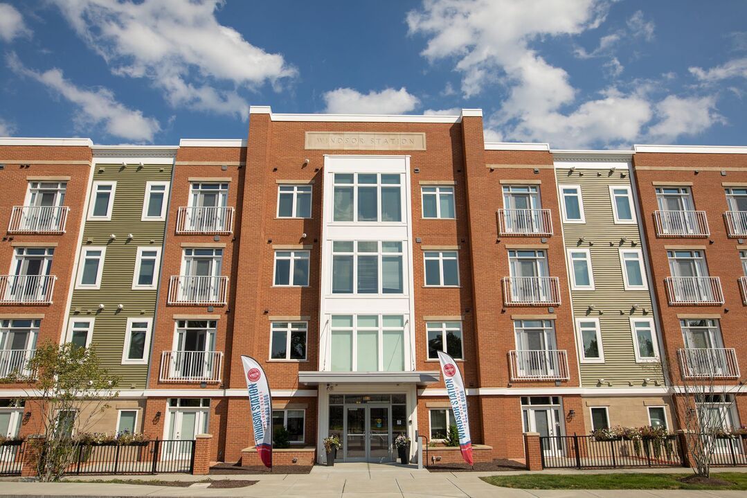 A large brick building with a lot of windows and balconies