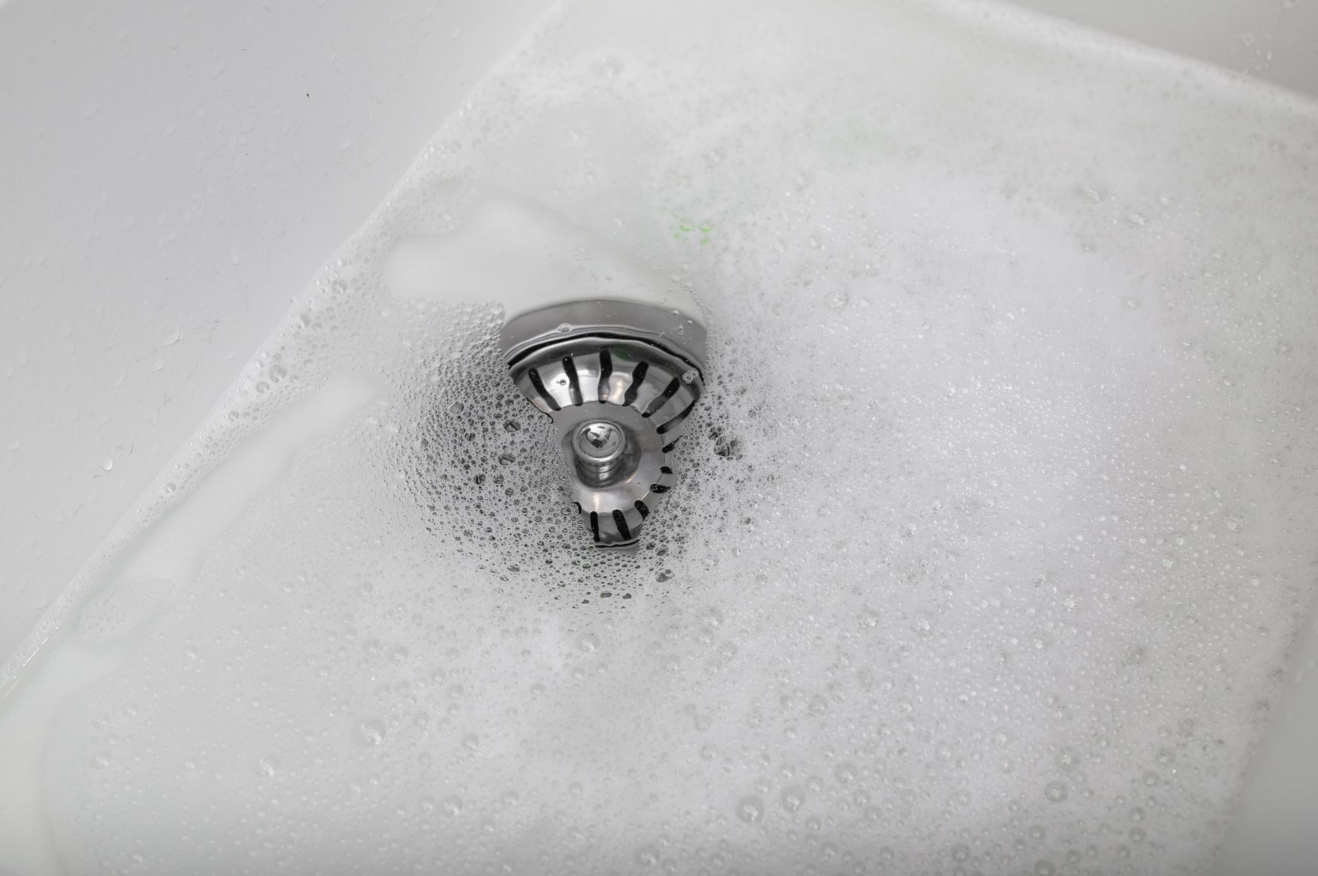 water draining slowly from kitchen sink