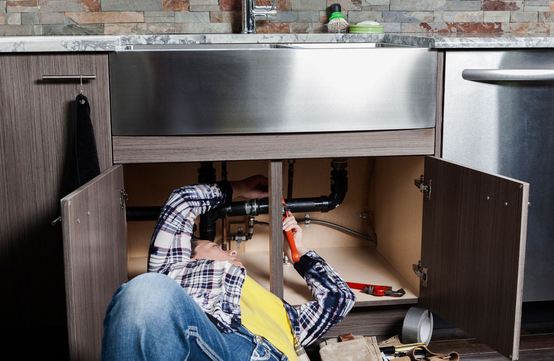 Plumbing Repair Under a Kitchen Sink Plumbing Repair Under a Kitchen Sink