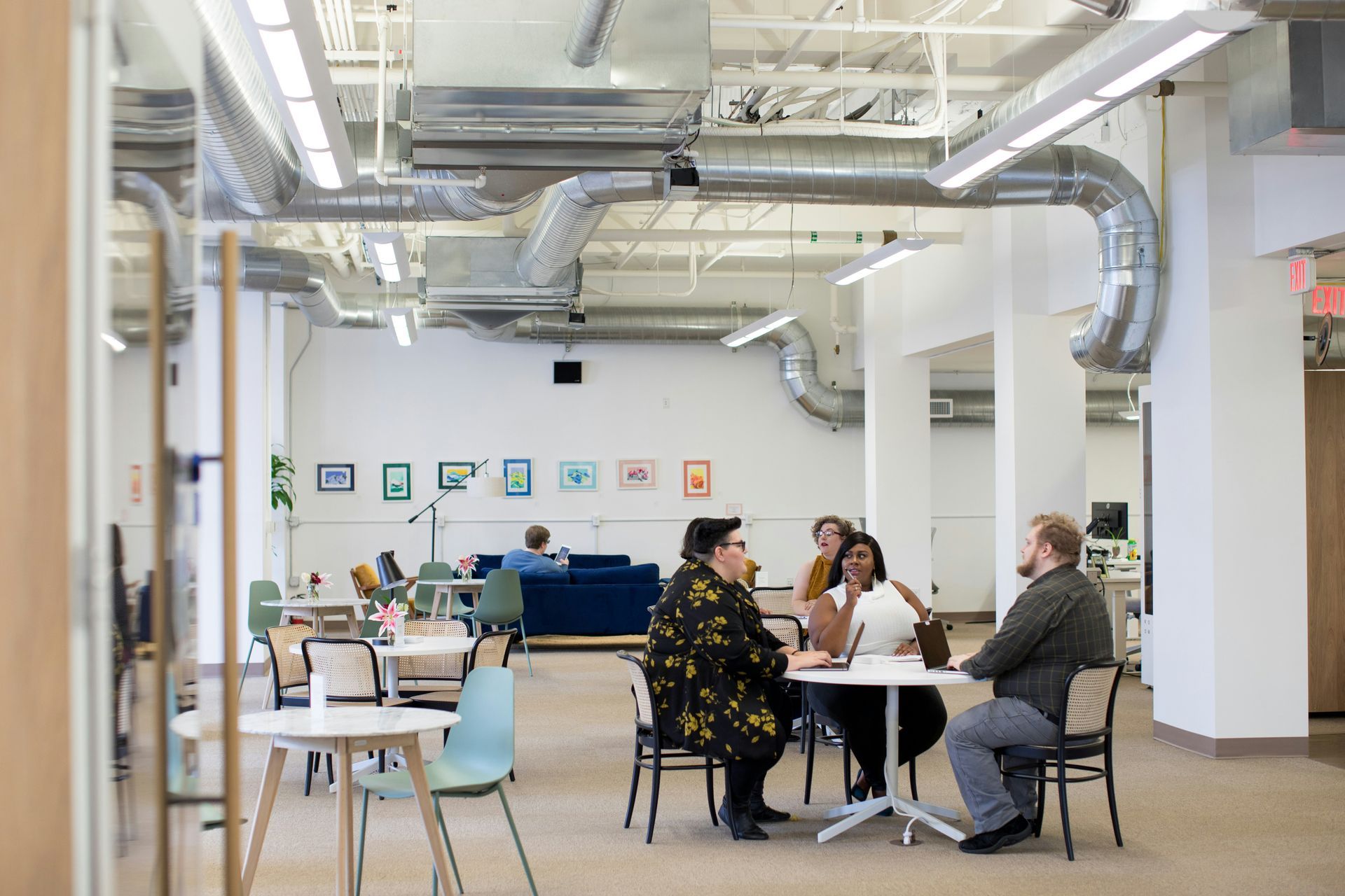 A group of people speaking together in an office space.
