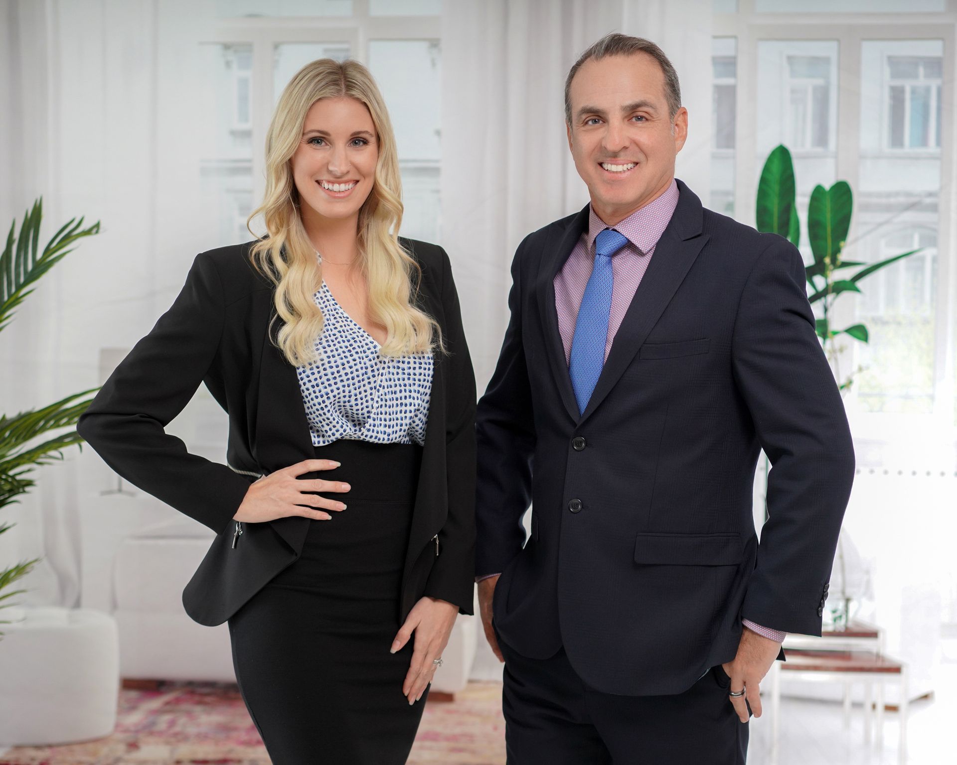 A man and a woman are standing next to each other in a room.