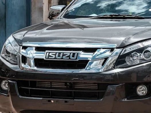 Front view of a black Isuzu SUV with chrome grille parked outdoors