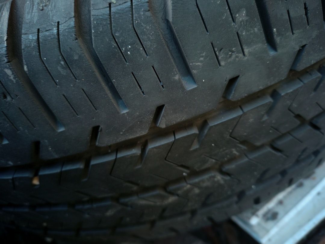 Close-up of a worn black tire tread with visible grooves and cracks