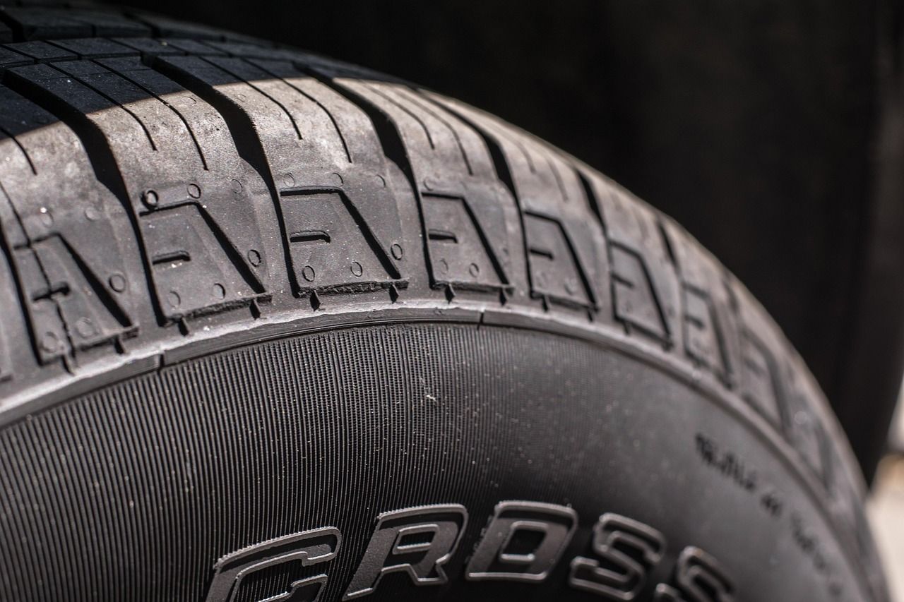 Close-up of a car tire tread and sidewall with visible embossed lettering