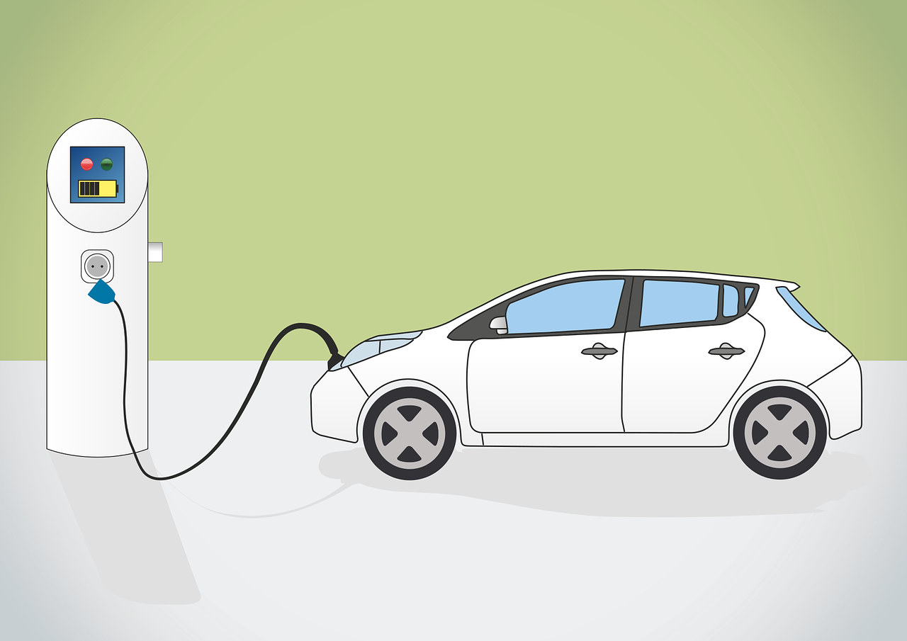 Electric car charging at a roadside station with a white hatchback plugged in