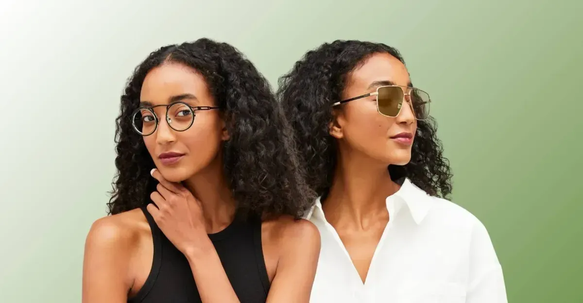 Two women posing against a light green background, one in a black top and one in a white shirt.