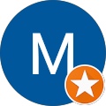 Blue circle with a white “M” and an orange star badge in the lower right corner.