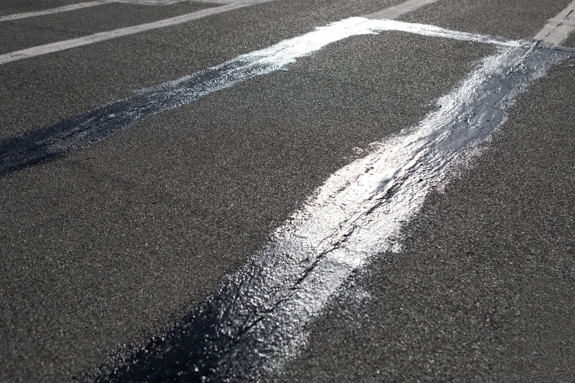 Black asphalt roof with a white rectangular outline and black sealant.