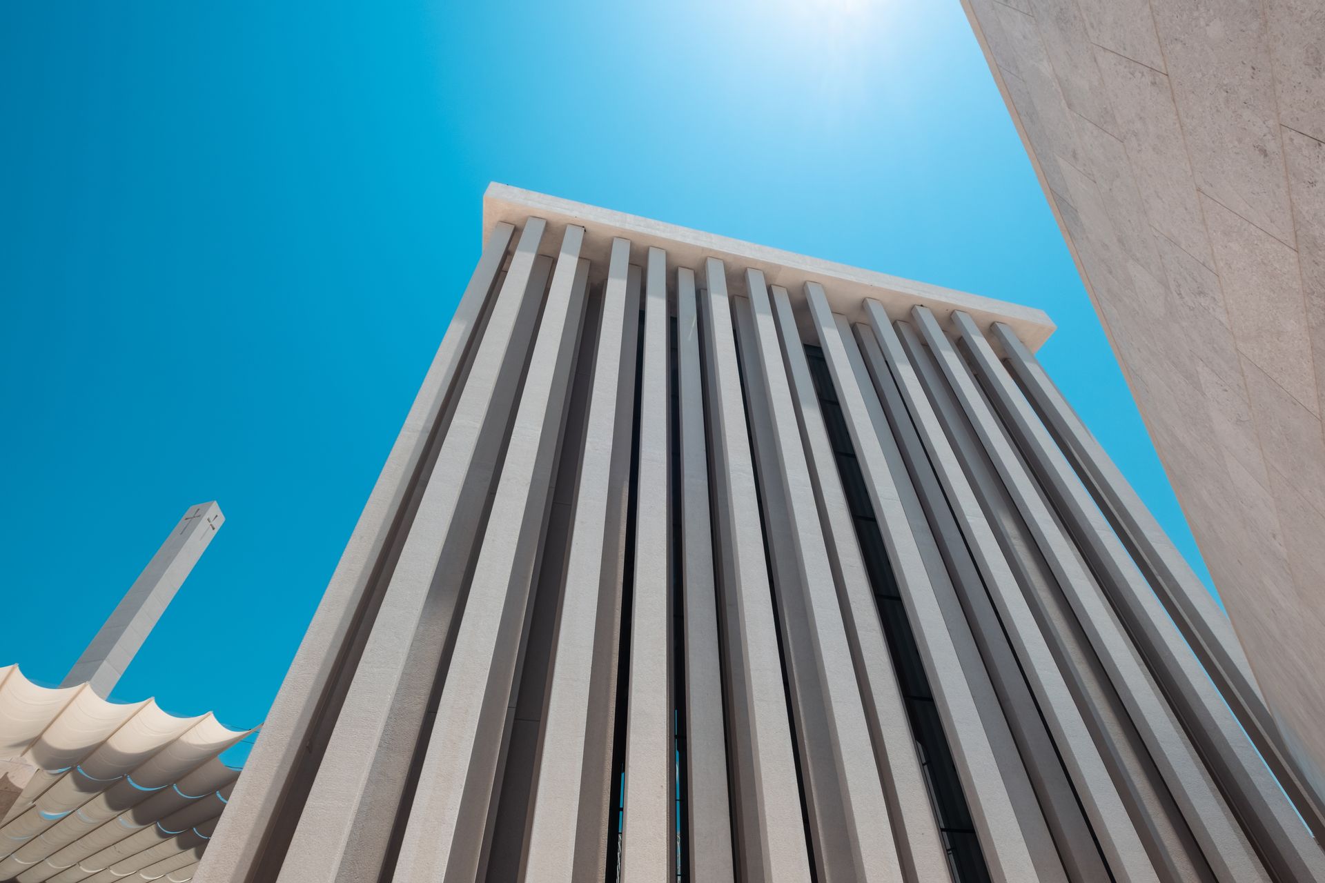Building with Vertical Concrete Columns against blue sky. Building with Vertical Concrete Columns against blue sky.