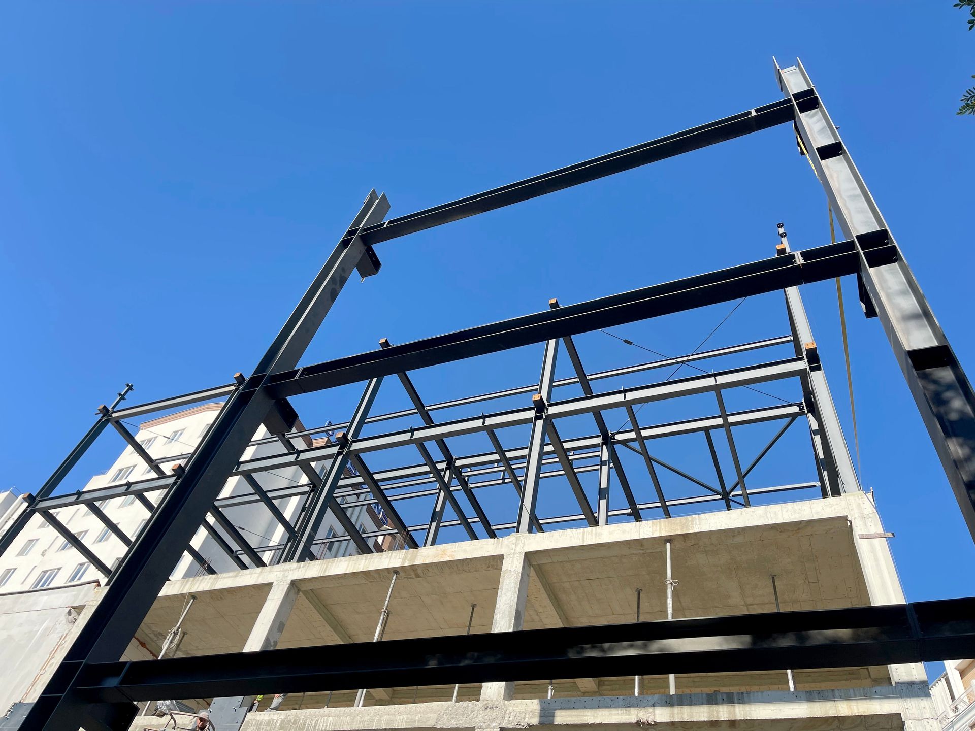 Steel frame under construction, showcasing structural engineering with modern building design.