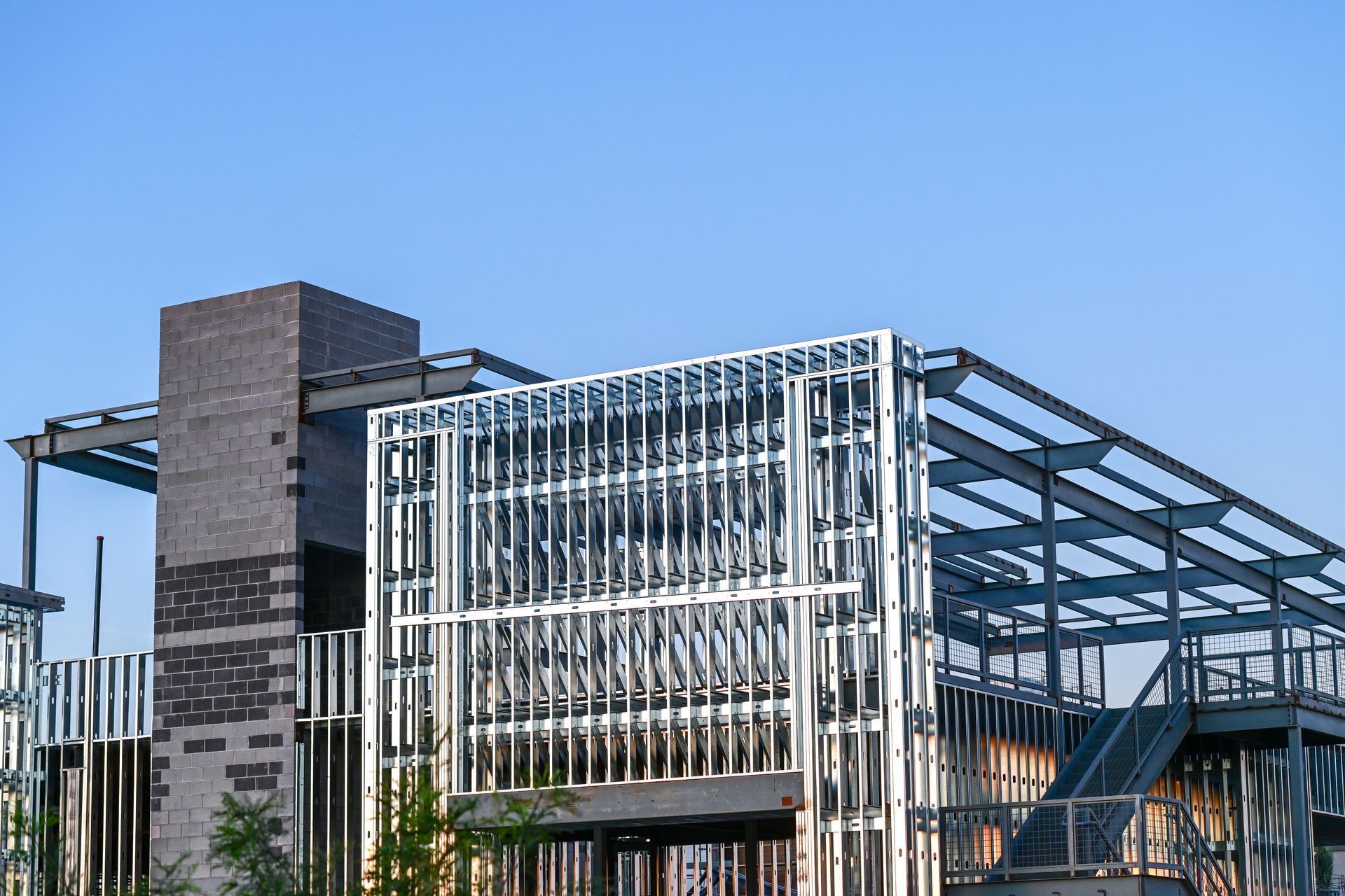 A commercial building under construction with steel framing and a masonry core, illustrating structu