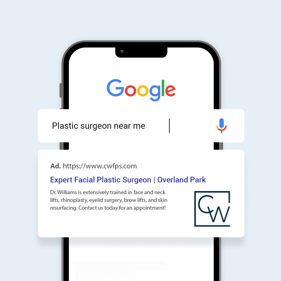 A cell phone is open to a google search for plastic surgeon near me.