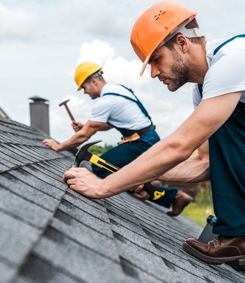 Handyman Repairing Roof with Coworker Handyman Repairing Roof with Coworker