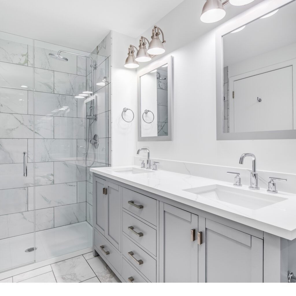 Bright white modern bathroom with double vanity, mirrors, glass shower, and chrome fixtures
