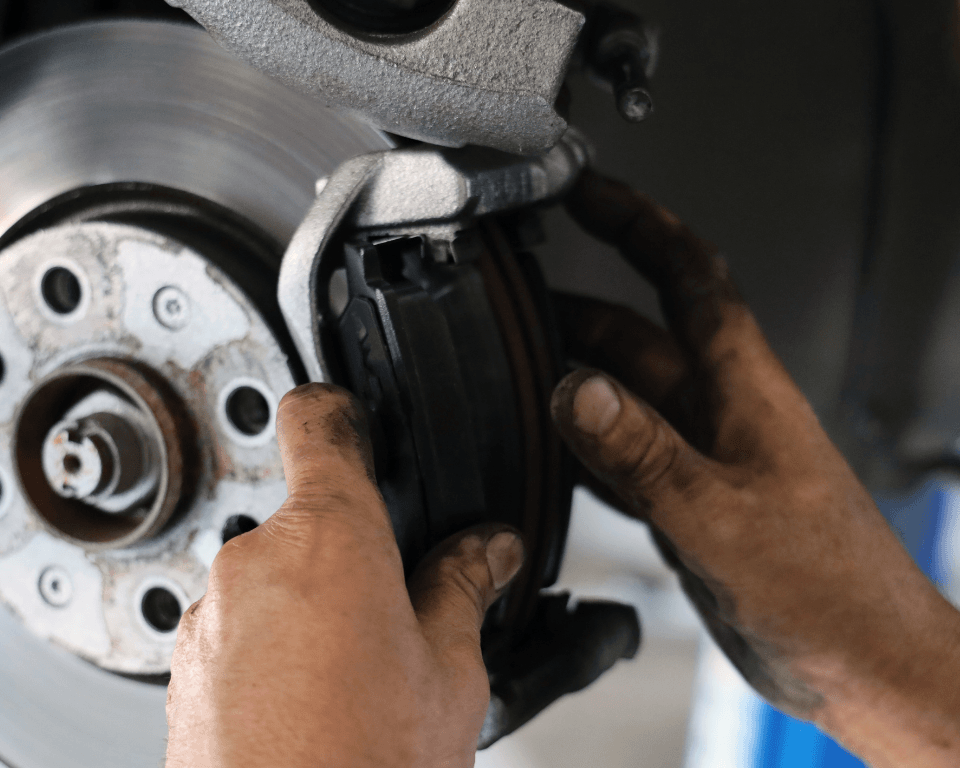 a mechanic changing brake pads