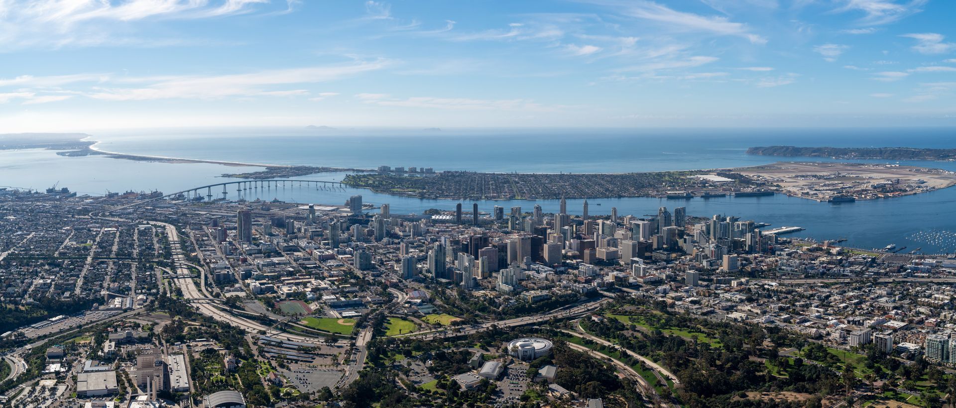 An aerial view of a city with a large body of water in the background.