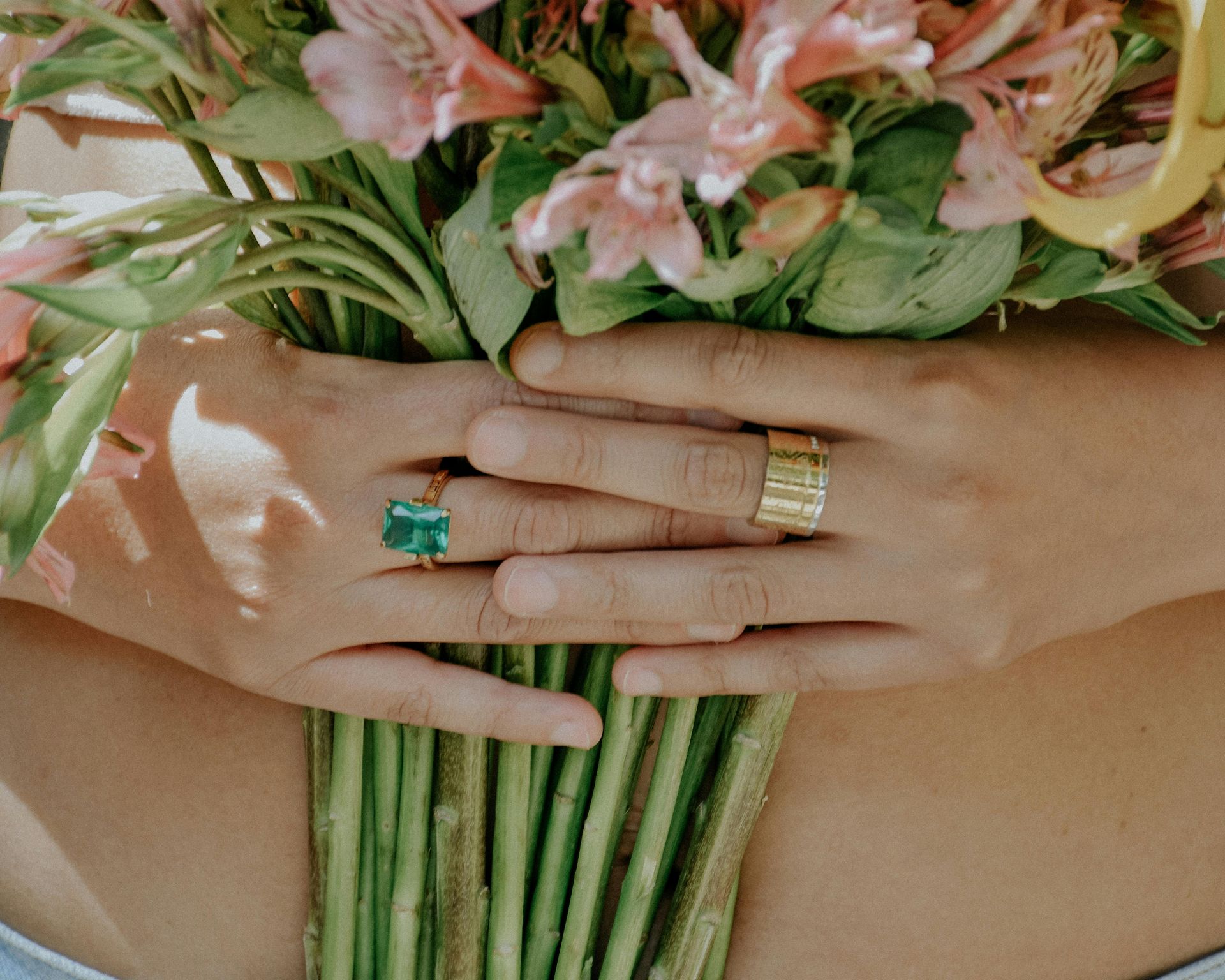 A Woman is Holding a Pair of Earrings in Her Hand — K. Smith & Son Jewellers In Caloundra, QLD
