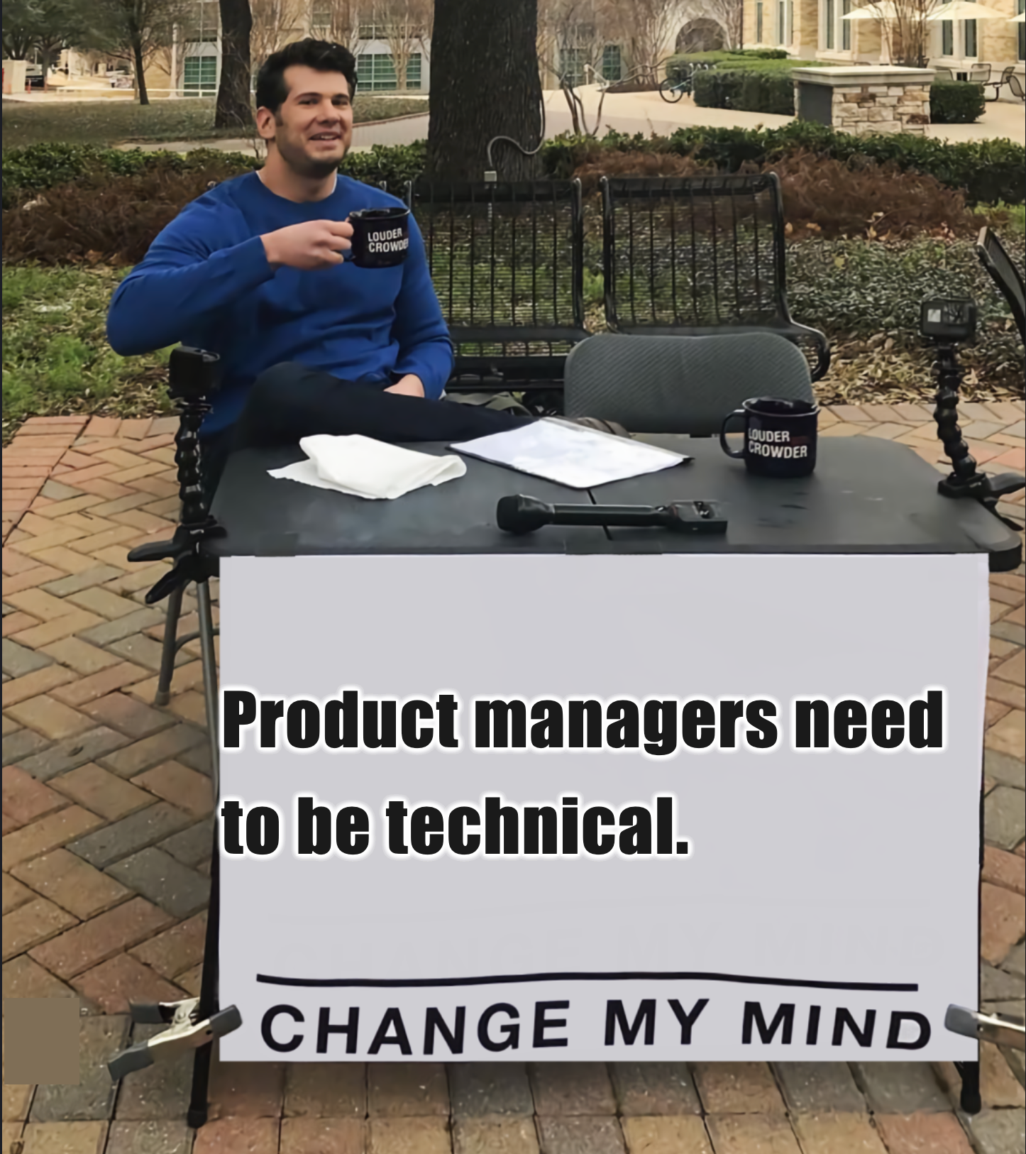 Man with sign that reads: Product Managers need to be Technical. Change my mind.