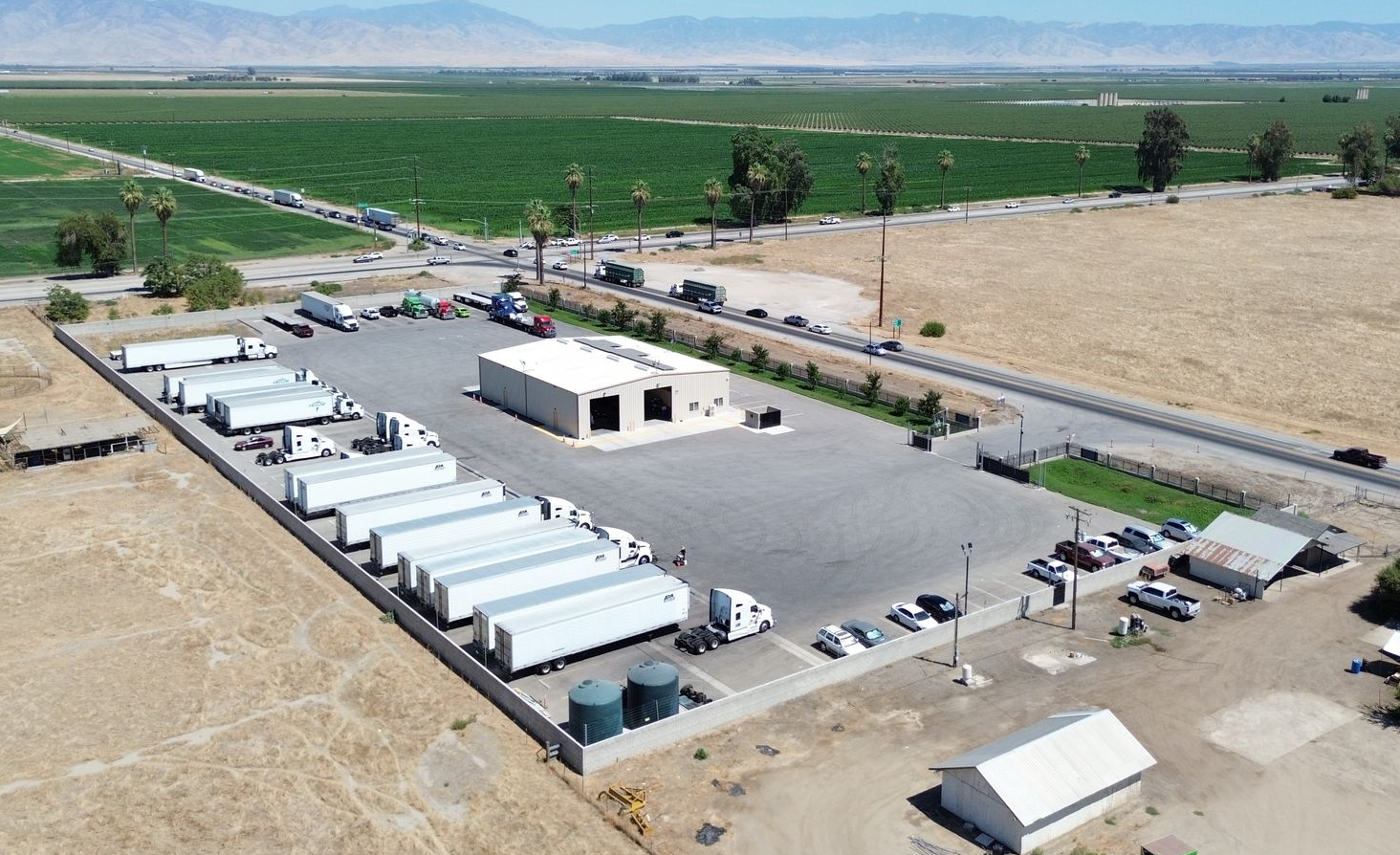 two white semi-trucks trailers are parked next to each other on a tansparent background .
