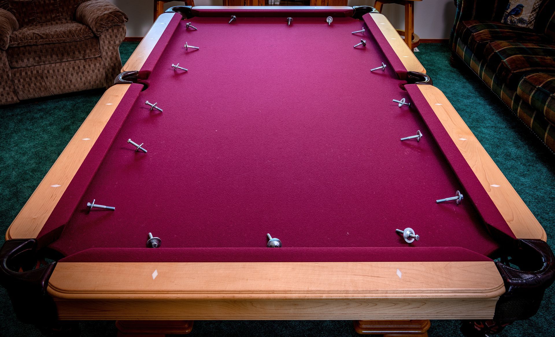 Home pool table disassembly with rail bolts on the felt Home pool table disassembly with rail bolts on the felt
