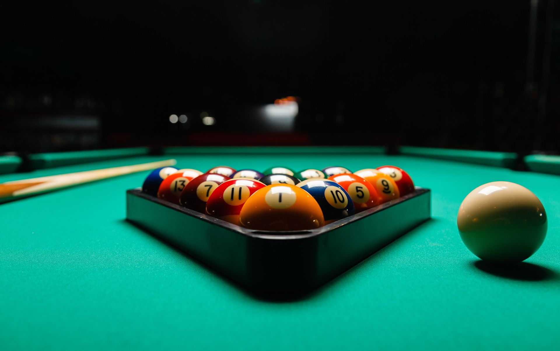 Billiard balls are arranged on a pool table ready for a game.
