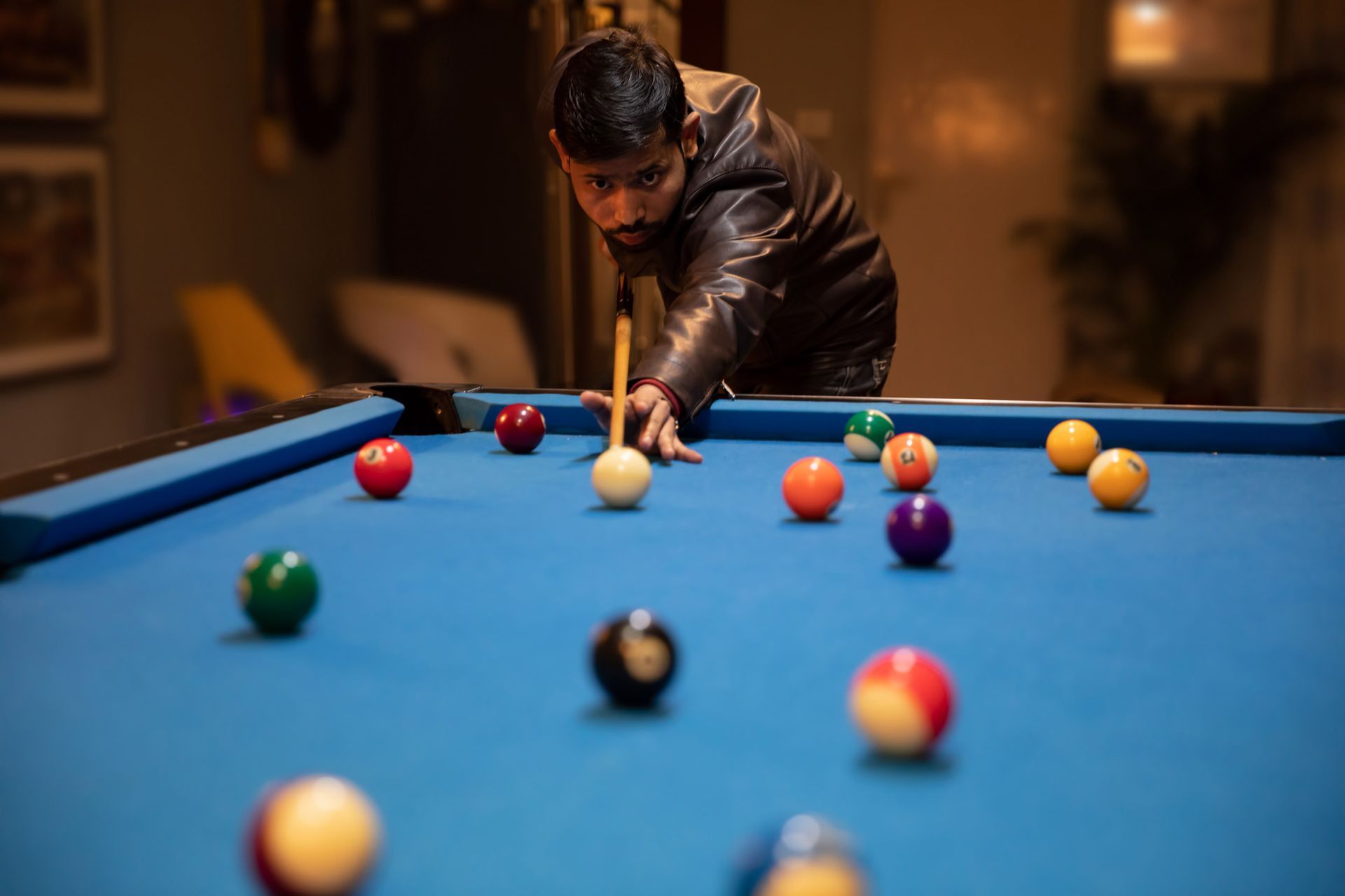 Pool table refelting by Atlas Billiards in Fort Lauderdale, FL, represented by a young man playing b