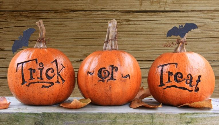 Three pumpkins with the words trick or treat written on them