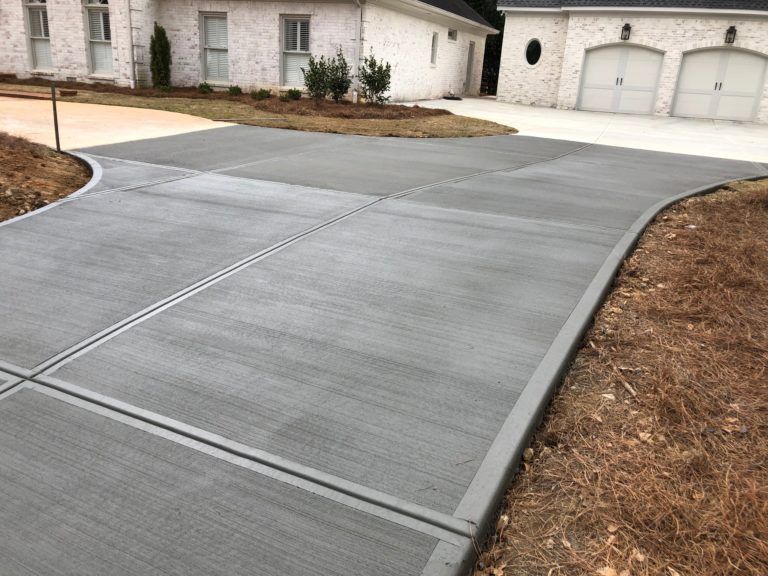 newly installed concrete flatwork in a house driveway