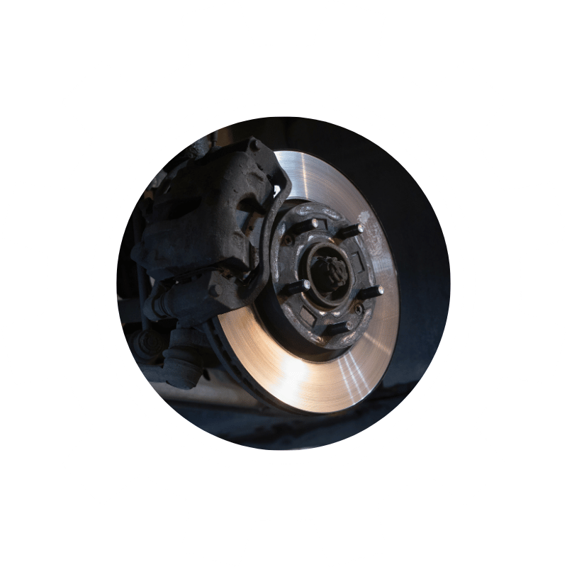 Close-up of a vehicle brake rotor and caliper assembly during brake inspection, repair, or replacement service.