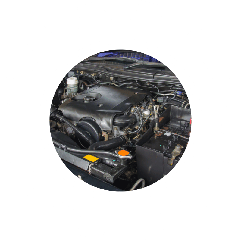 Engine compartment with visible intake and mechanical components, representing engine diagnostics, maintenance, and repair services.