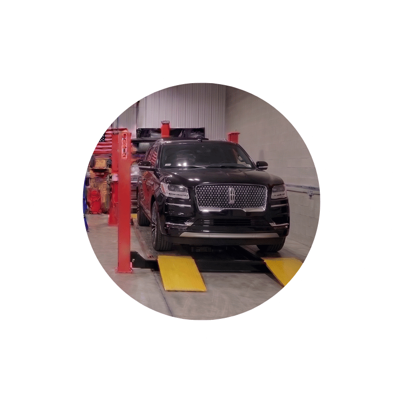 Black Lincoln SUV undergoing wheel alignment service to improve ride quality and vehicle stability.