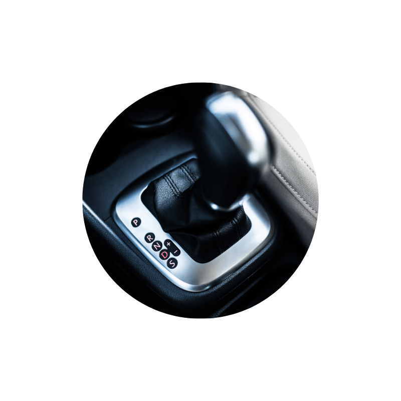 Automatic transmission gear selector inside a vehicle, representing transmission diagnostics, maintenance, and repair services.