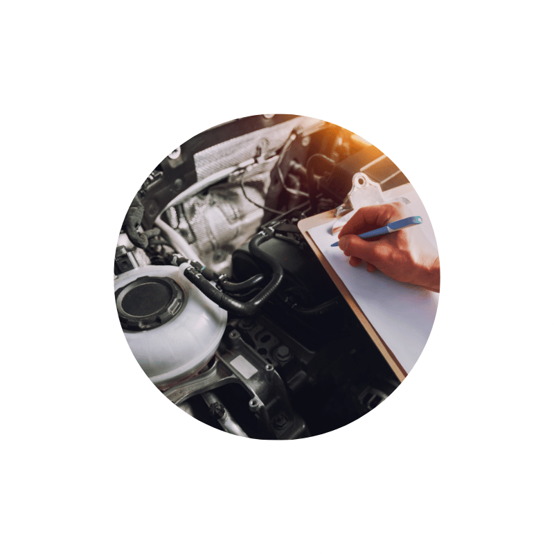 Technician completing a vehicle inspection checklist during a comprehensive pre-purchase or used vehicle evaluation.