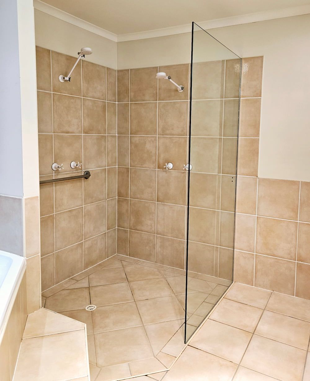 A Bathroom With A Walk In Shower With A Glass Door — Mobile Shower Door Doctor In Mountain Creek, QLD