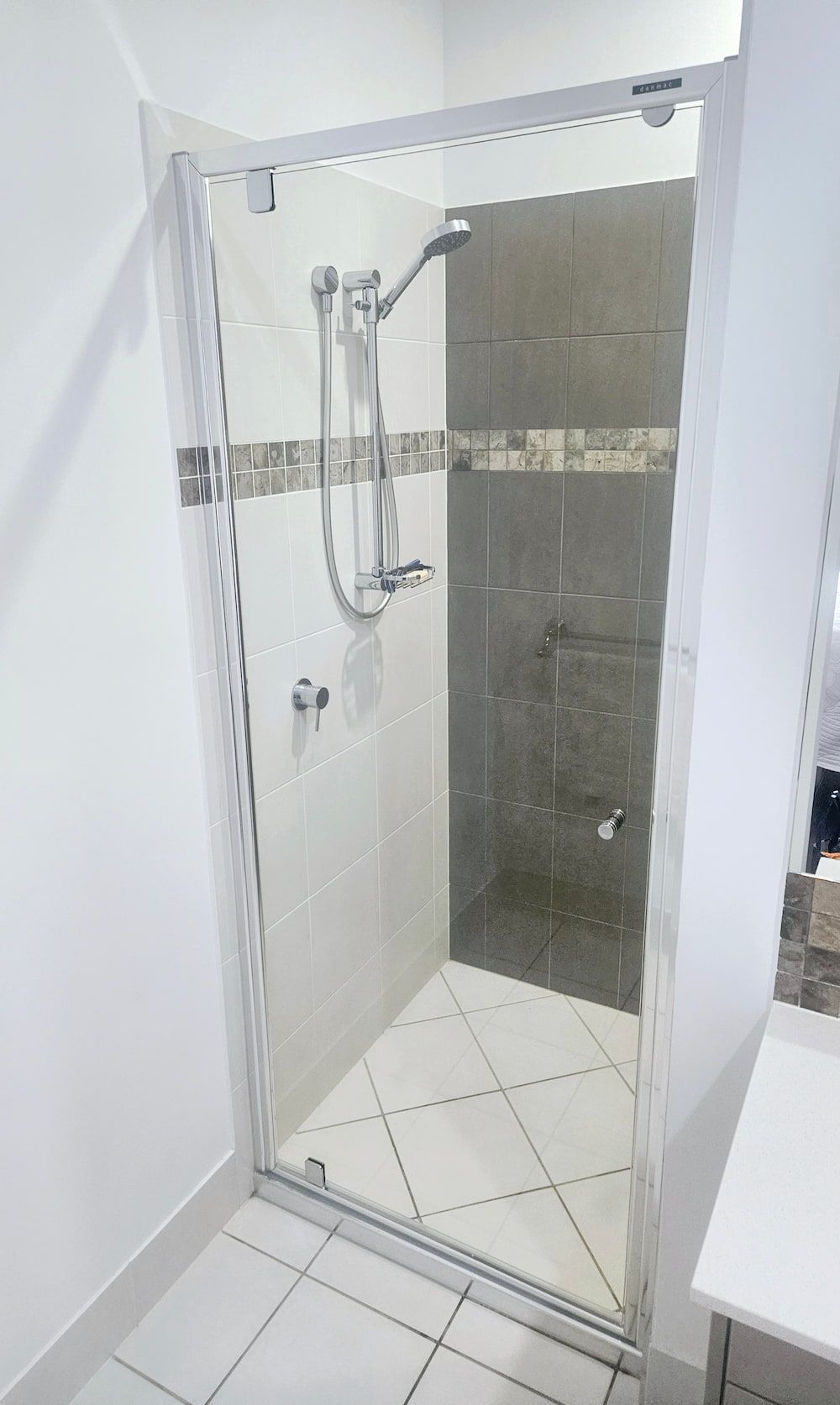 A Bathroom With A Walk In Shower And A Sink — Mobile Shower Door Doctor In Mountain Creek, QLD
