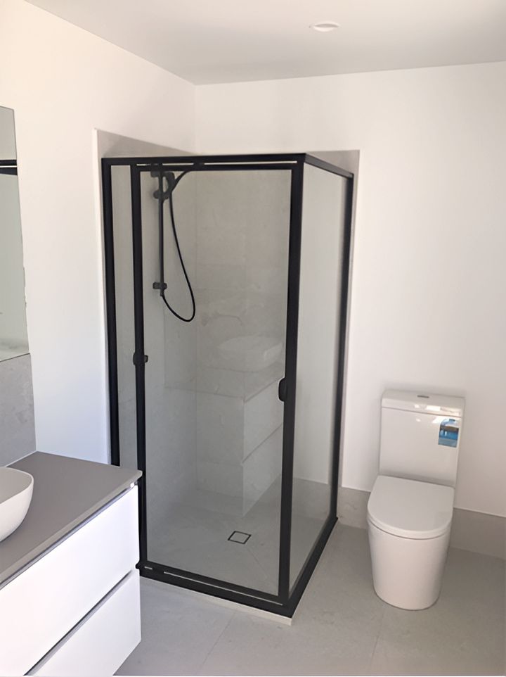 A Bathroom With A Toilet And A Shower Stall — Mobile Shower Door Doctor In Mountain Creek, QLD