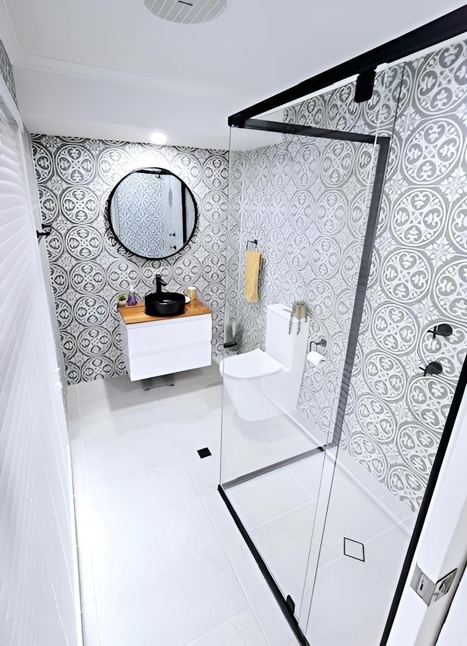 A Bathroom With a Walk in Shower, Sink, Toilet and Mirror — Mobile Shower Door Doctor In Noosa, QLD