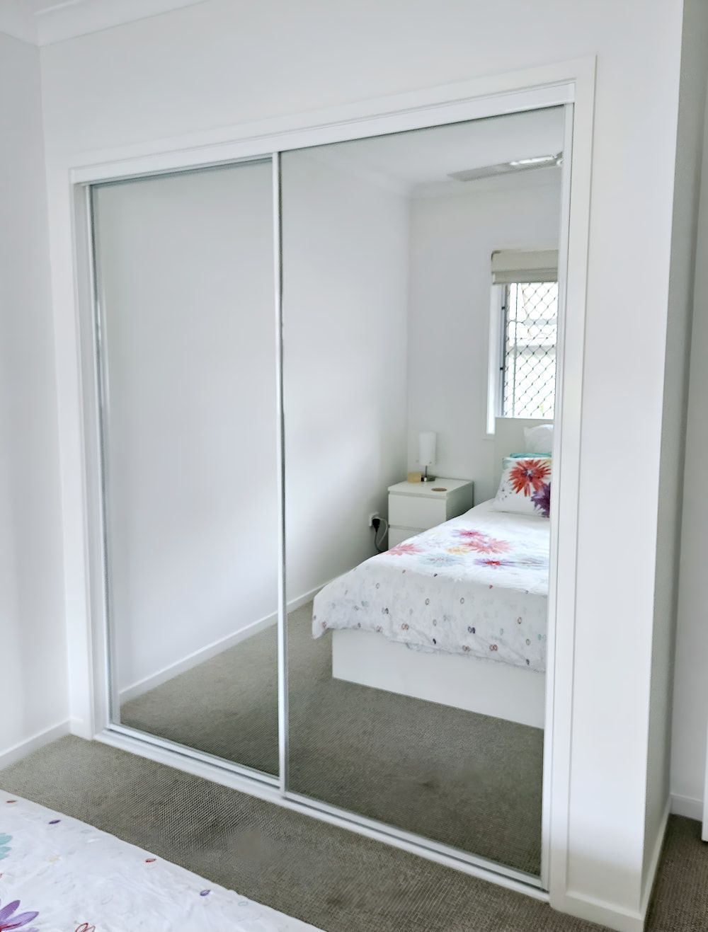 A Bedroom With A Bed And A Mirrored Door — Mobile Shower Door Doctor In Mountain Creek, QLD