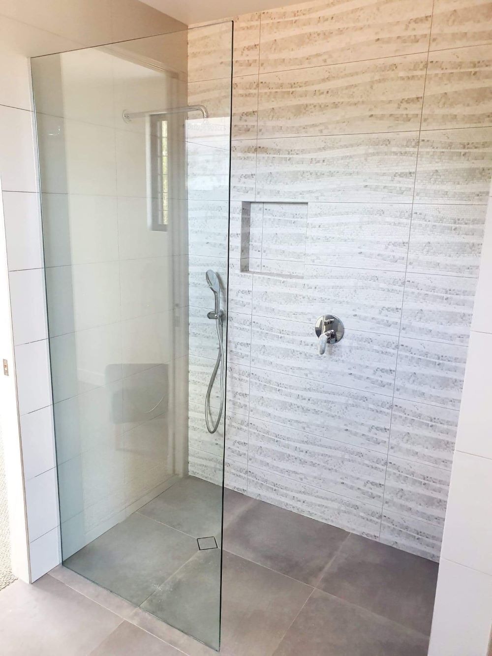 A Walk In Shower With A Glass Door And A Shower Head — Mobile Shower Door Doctor In Mountain Creek, QLD