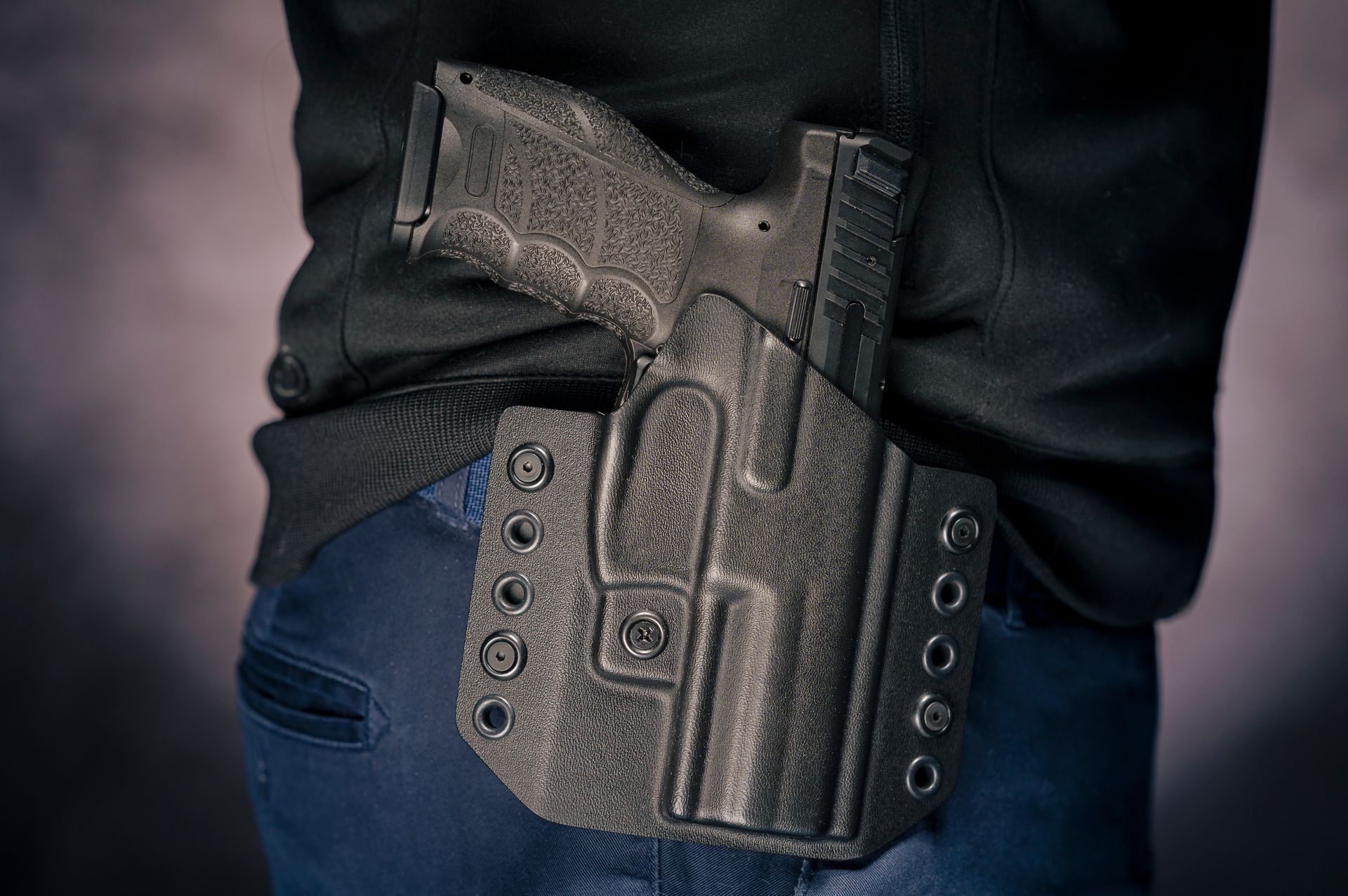 a firearm tucked into a belt